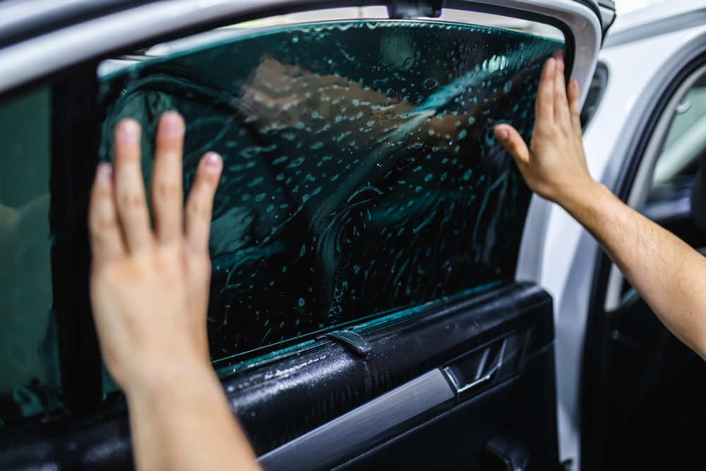 Window tint installers is placing the tint carefully