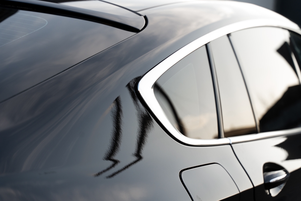 Close up view of a black vehicle after installing the window tint
