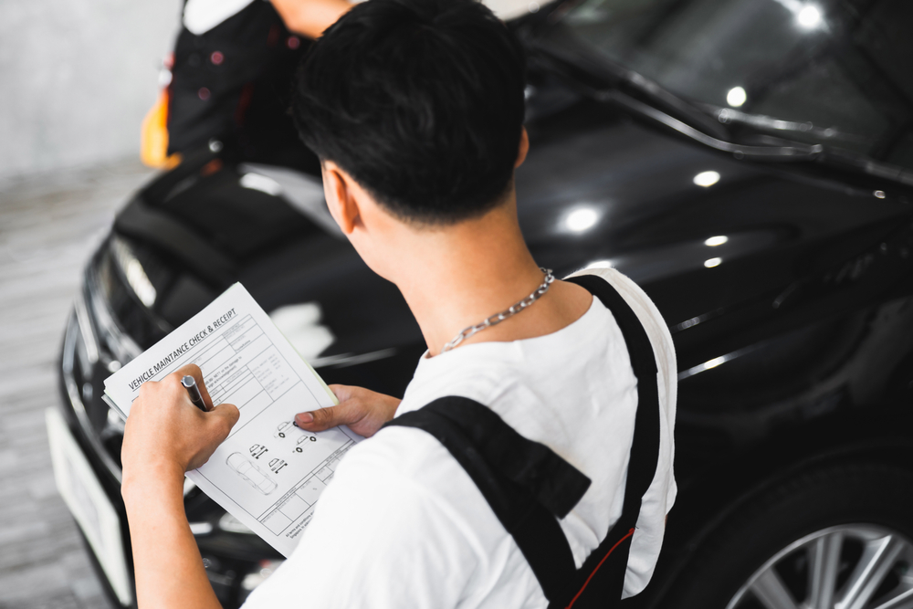 Car wrapping specialists is conducting assessment of client's vehicle