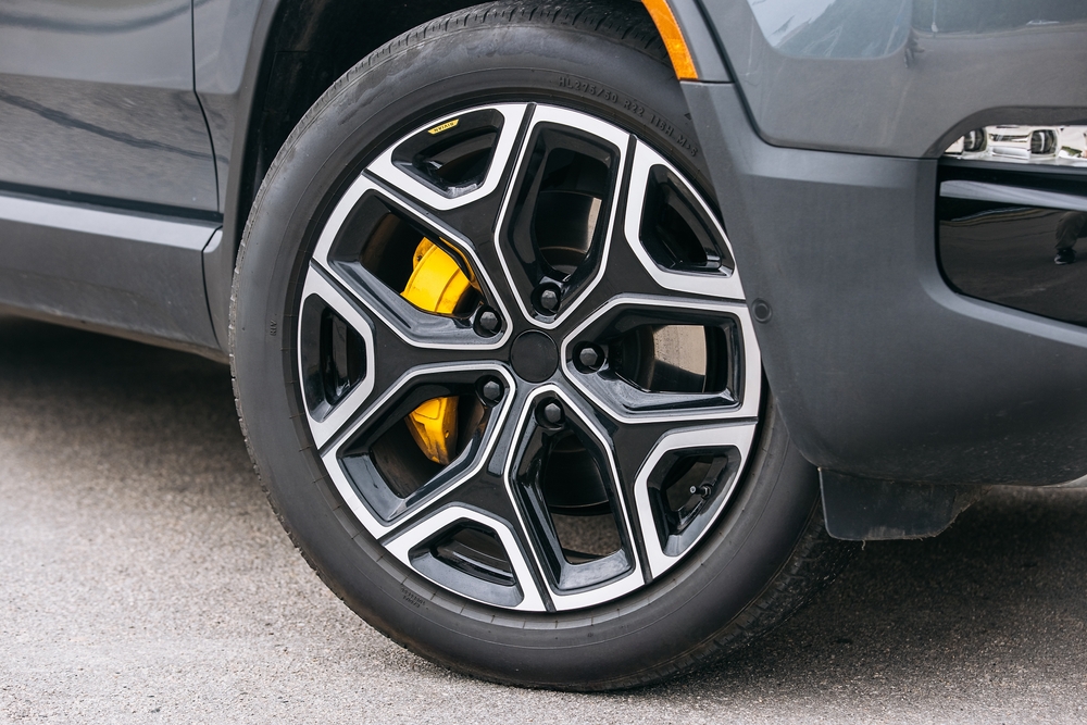 Modern design of Wheels with yellow brake caliper in the background