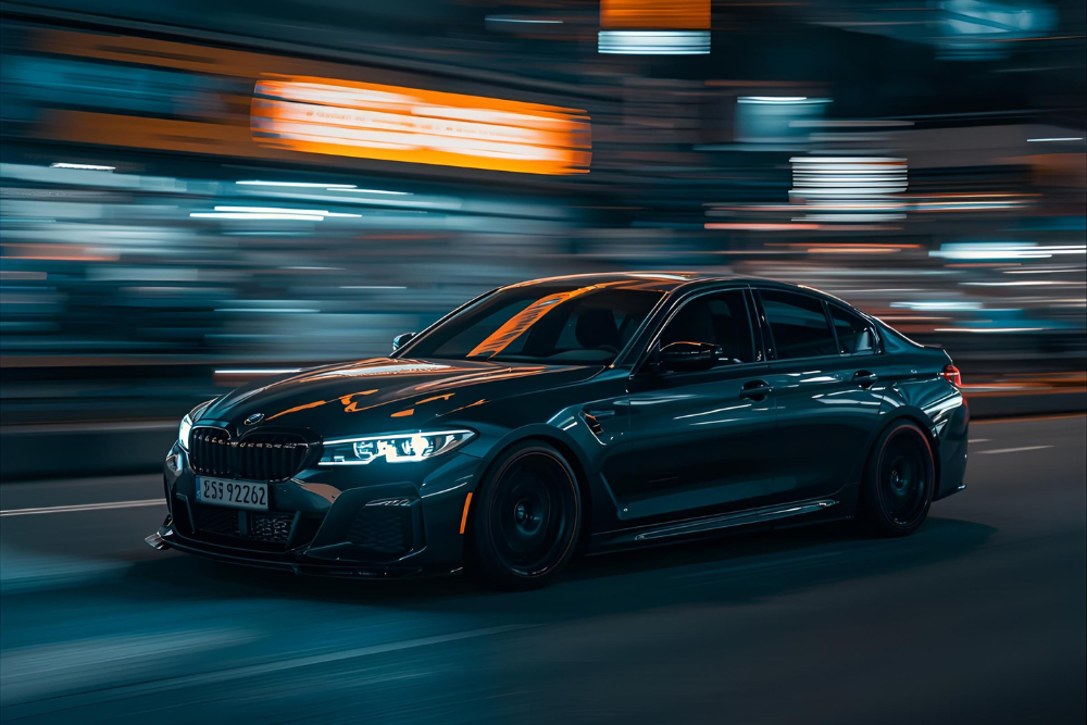 Side view of a sedan car speeding up with blur background