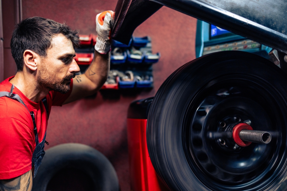 Experienced Mechanic is conducting wheel alignment
