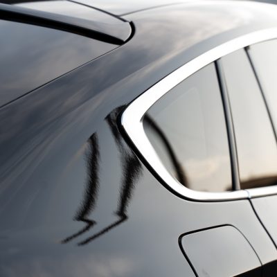 Close up view of a black vehicle after installing the window tint